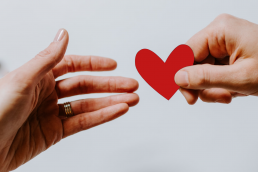 Man handing a woman a heart shape